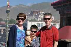 
Charlotte Ryan, Dangles, Peter Ryan, and Jerome Ryan pose on the roof of the Jokhang Temple with the Potala Palace behind.
